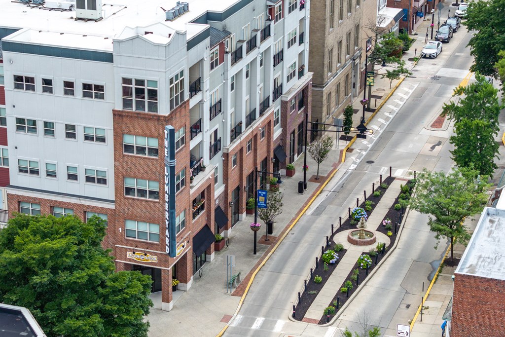 A city street with buildings on either side and a crosswalk in the middle.