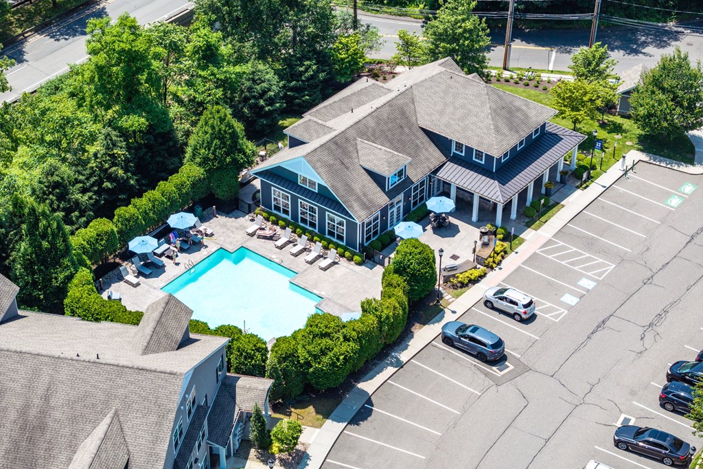 A large building with a pool in front of it.