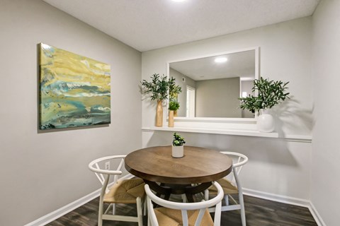 a dining room with a table and chairs and a mirror at Timberwalk at Mandarin Apartment Homes, Florida, 32257