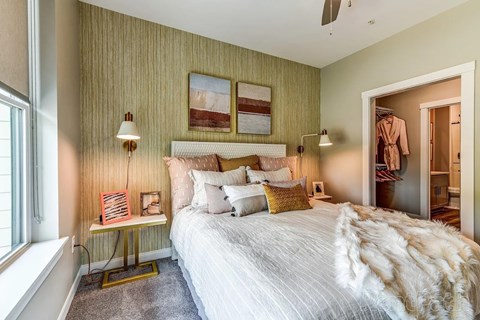 A bedroom with a large bed and a window.
