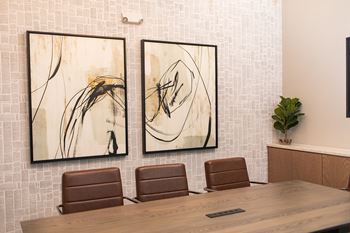 two paintings hanging on a wall in a conference room at The Yards at Malvern, Malvern, PA
