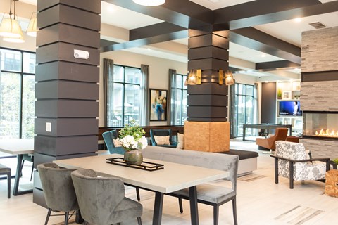 A modern dining room with a large table and chairs.
