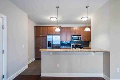 A kitchen with a wooden cabinet and a granite countertop.