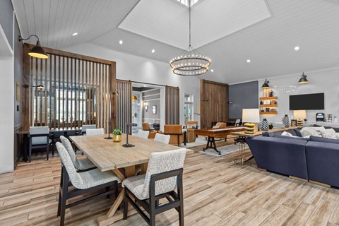 A modern dining room with a wooden table and chairs.