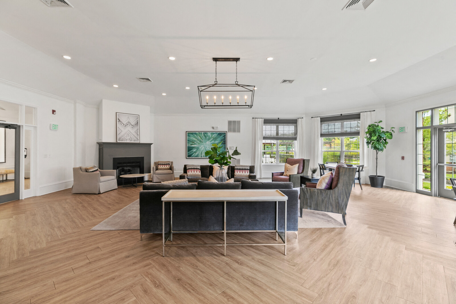 a living room with a fireplace and a table and chairs