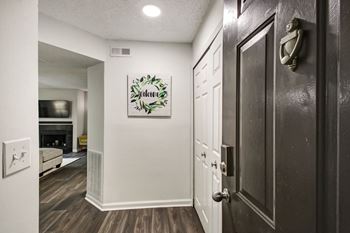 a hallway with a door and a living room with a fireplace at Timberwalk at Mandarin Apartment Homes, Florida, 32257