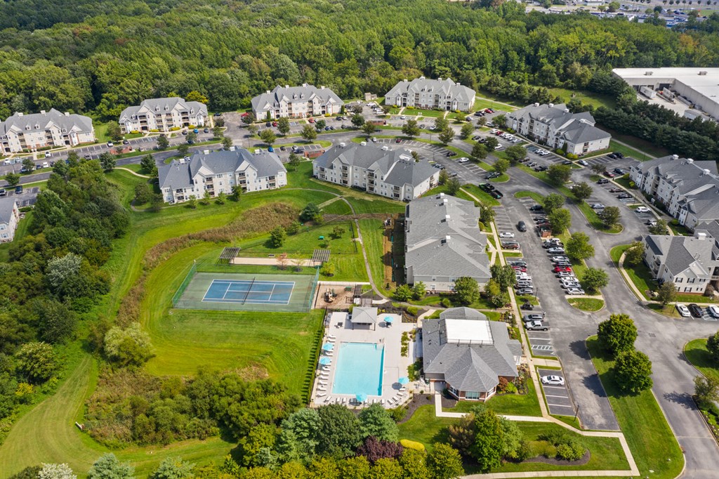 an aerial view of a neighborhood with houses and a swimming pool at The Austin Apartment Homes, Deptford, New Jersey