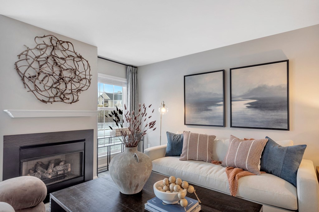 a living room with a white couch and a fireplace at The Austin Apartment Homes, Deptford