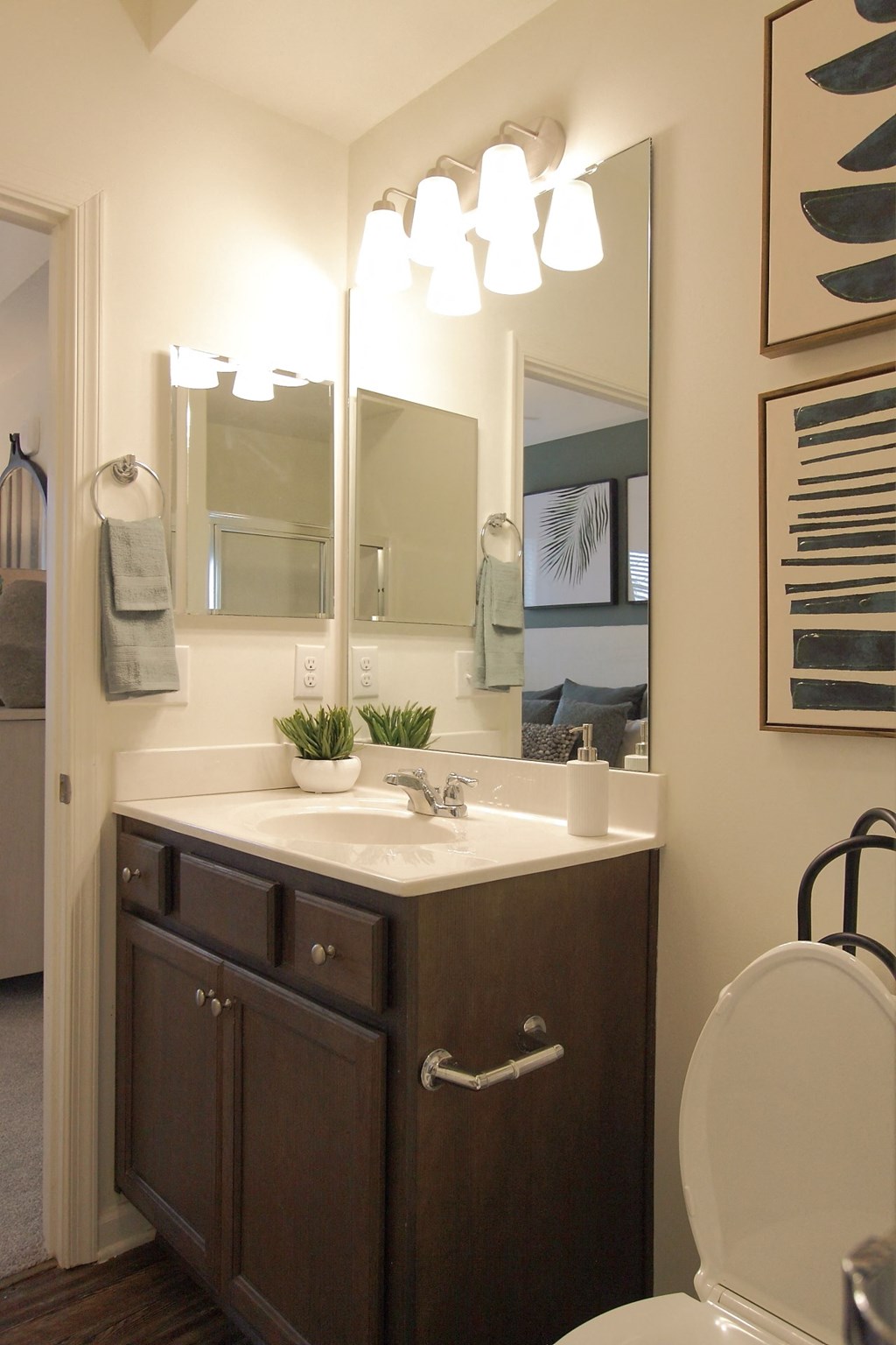 a bathroom with a sink and a mirror and a toilet  at Carillon Woods, Millsboro