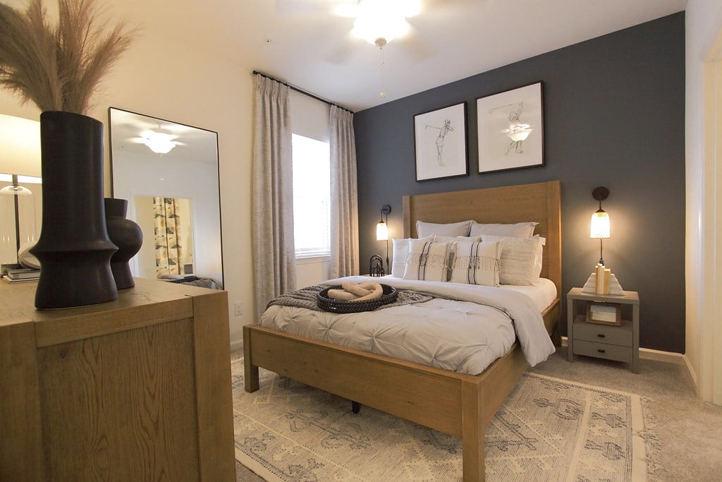 a bedroom with a bed and a dresser and a window  at Carillon Woods, Delaware