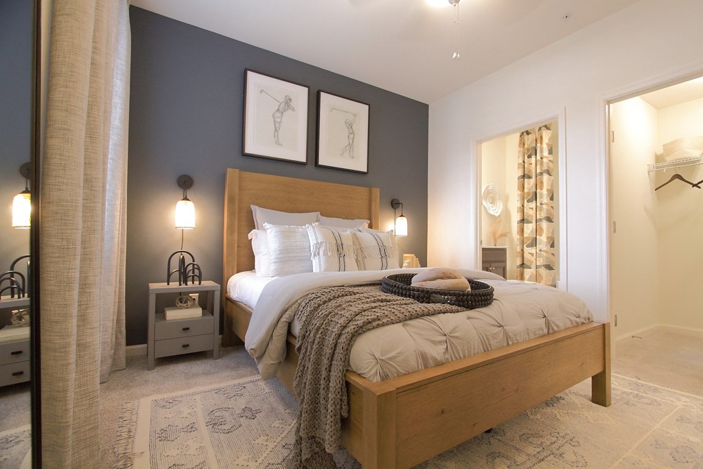 a bedroom with a bed and two lamps and a closet  at Carillon Woods, Millsboro, Delaware