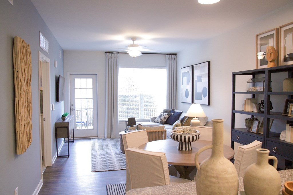 a living room and dining room with a couch and a table  at Carillon Woods, Millsboro, Delaware
