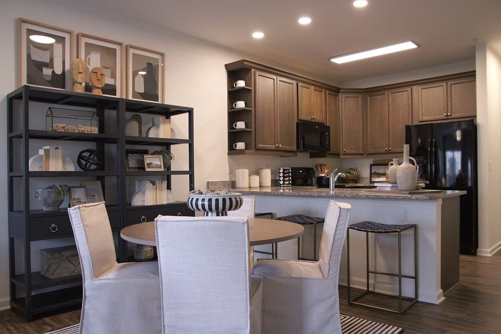 a kitchen and dining room with a table and chairs  at Carillon Woods, Millsboro