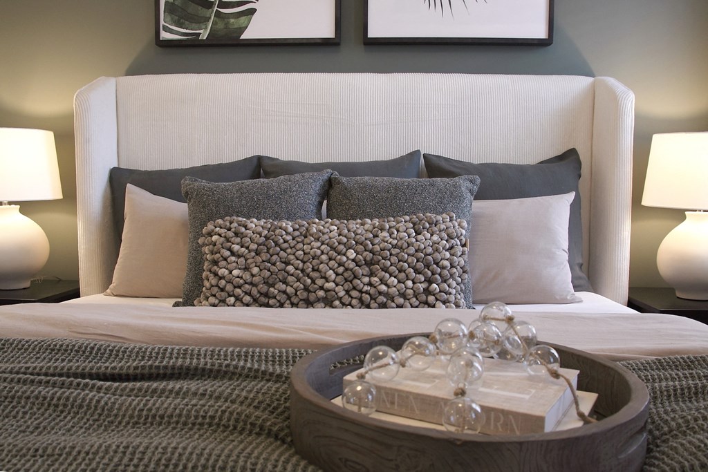 a bed with pillows and a tray with glasses on it  at Carillon Woods, Delaware, 19966