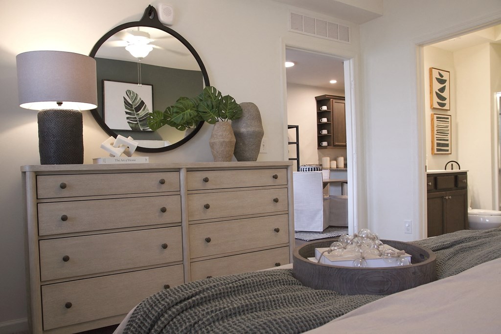 a bedroom with a dresser and a bed with a mirror on it  at Carillon Woods, Millsboro, DE, 19966