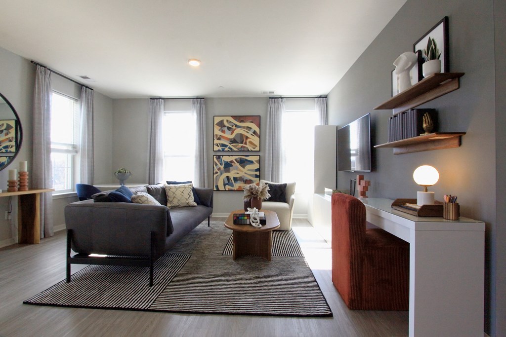 A living room with gray walls and a brown couch  at Barclay Chase Apartment Homes, New Jersey