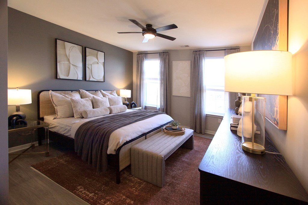 A bedroom with a bed and a ceiling fan  at Barclay Chase Apartment Homes, Marlton