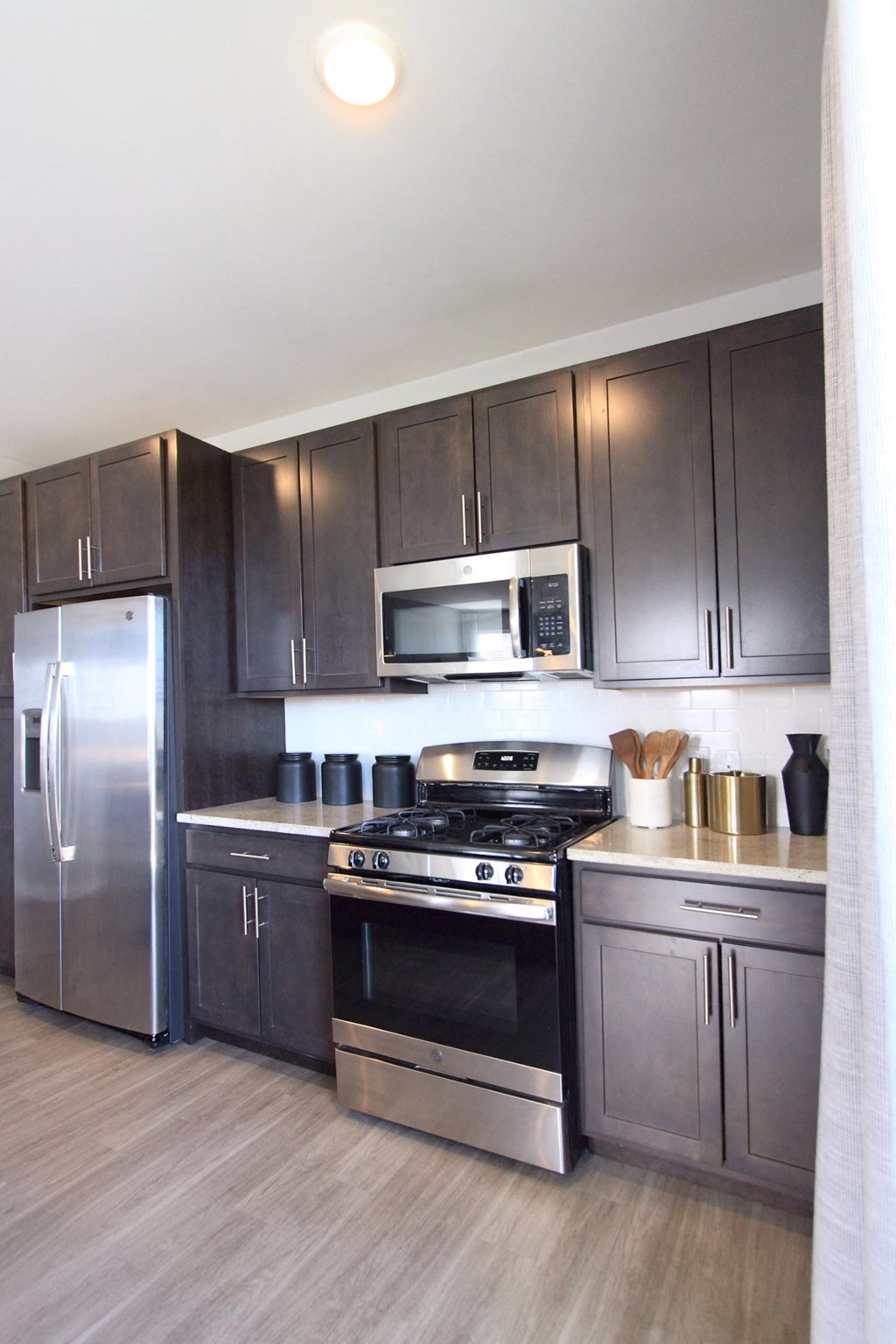 A kitchen with dark cabinets and stainless steel appliances  at Barclay Chase Apartment Homes, New Jersey