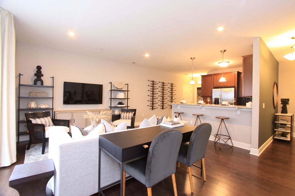 A living room and kitchen with a dining table and chairs  at Barclay Glen Apartments, New Jersey, 08094
