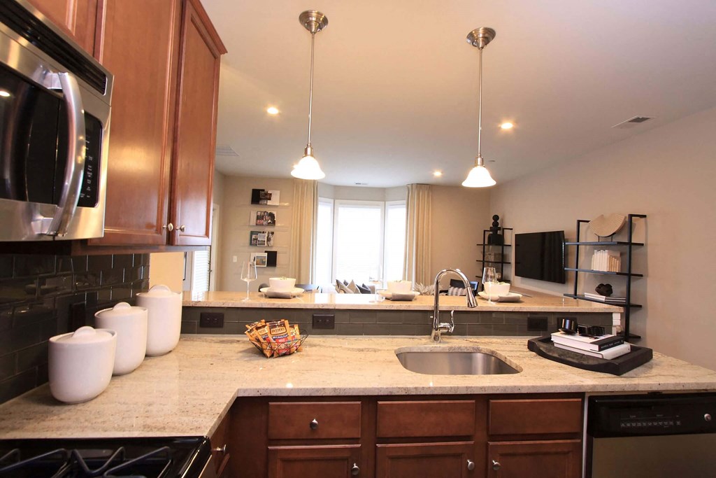 A kitchen with a sink and a microwave  at Barclay Glen Apartments, Williamstown, NJ