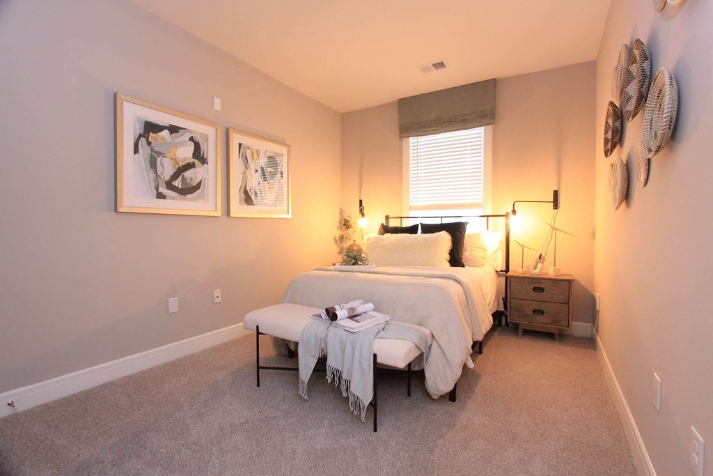 A bedroom with a bed and two paintings on the wall  at Barclay Glen Apartments, New Jersey, 08094