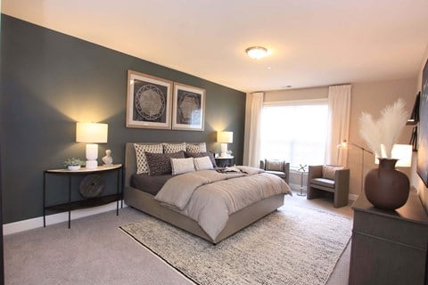 A bedroom with a bed and two night stands  at Barclay Glen Apartments, New Jersey