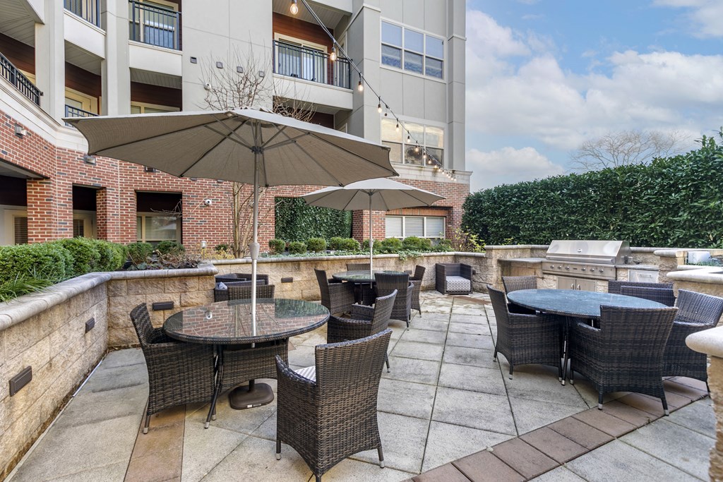 an outdoor patio with tables and chairs and umbrellas  at The Collings at the Lumberyard, New Jersey