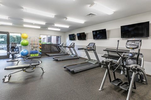 a gym with treadmills and other exercise equipment at The  Collings at Lumberyard