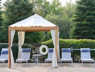 a gazebo with chairs and a table under it