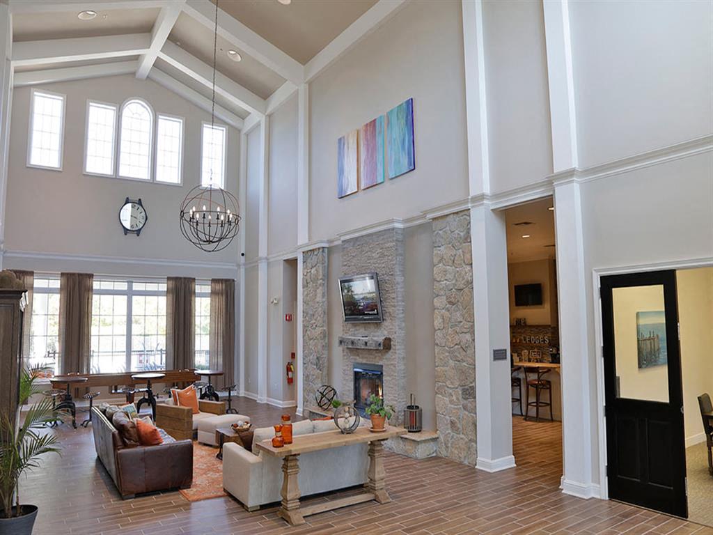 a large living room with couches and a fireplace