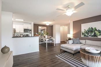 Champions Walk living room with a ceiling fan and hardwood floors