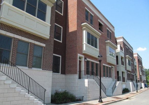 a row of brick buildings on the side of a street
