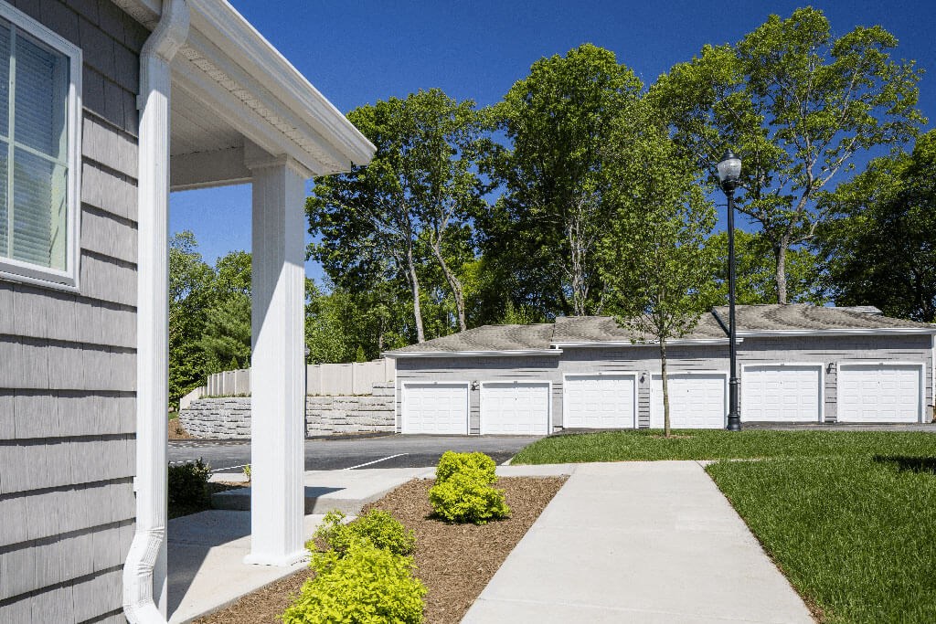 a house with a driveway and a white fenceat Merion Stratford Apartment Homes, Stratford, CT