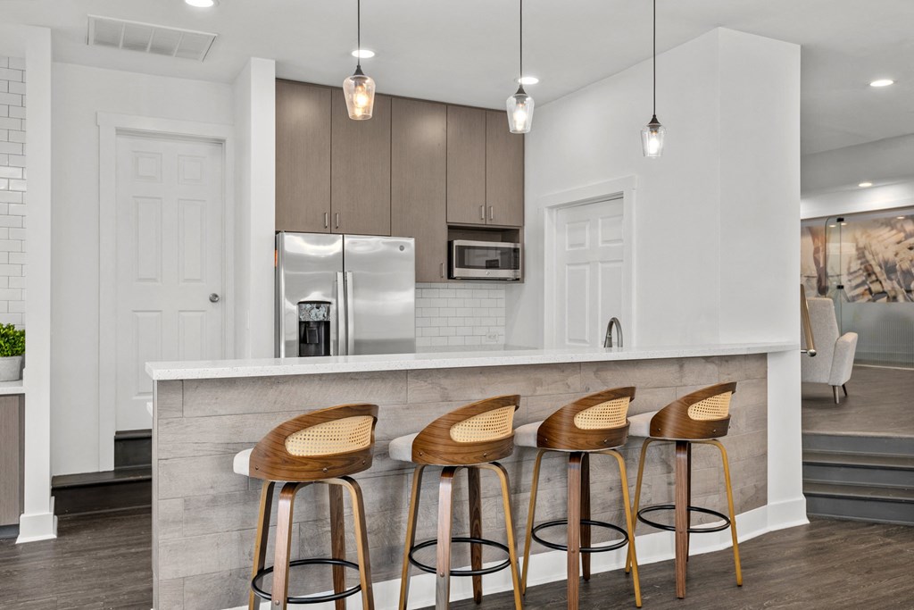 A kitchen with a white counter and bar stools. at Eagle Ridge Apartments, Pennsylvania, 15146