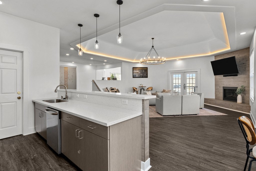 A modern kitchen with a large island and a dining area in the background. at Eagle Ridge Apartments, Pennsylvania, 15146