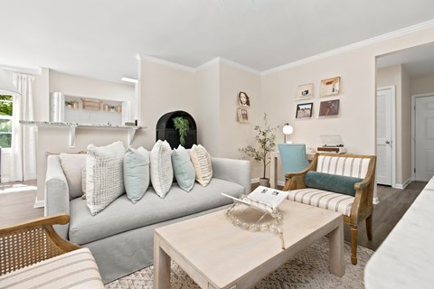 A living room with a grey couch and a coffee table.