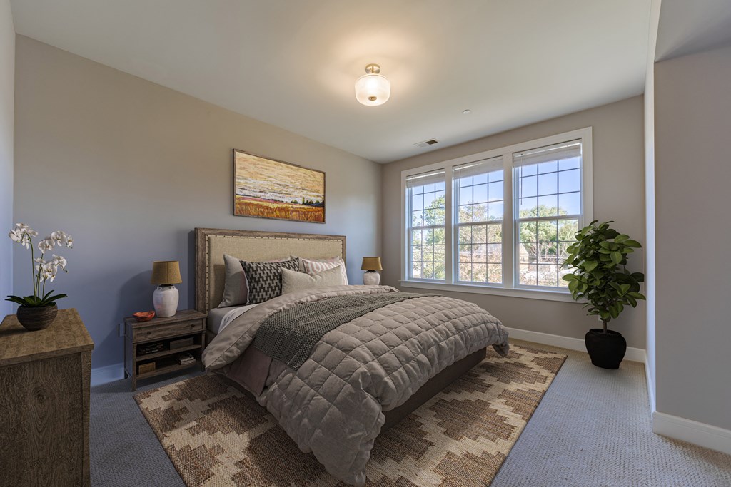 A bedroom with a large bed and a painting on the wall.