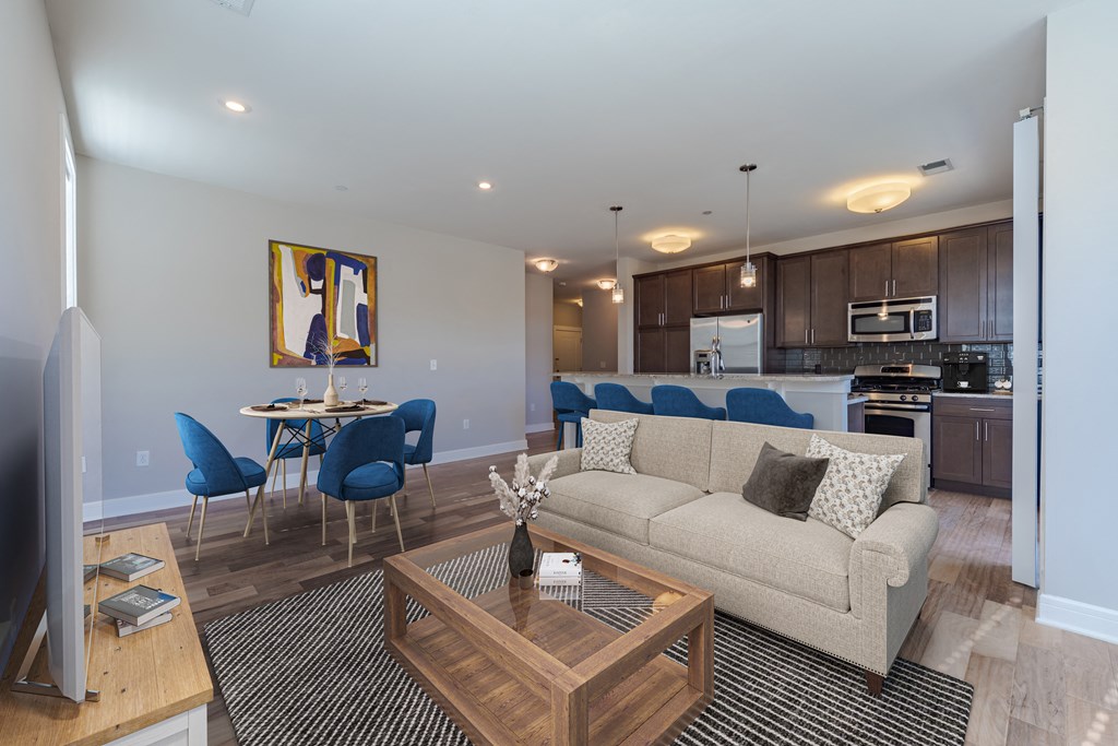 A living room with a couch, chairs, and a coffee table.