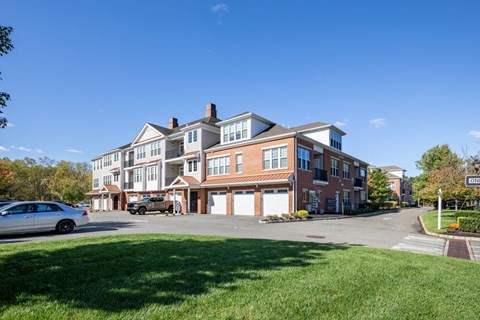 a large brick building with cars parked in front of it