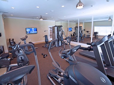 Fitness room with workout equipment and TV - Photo Gallery 3