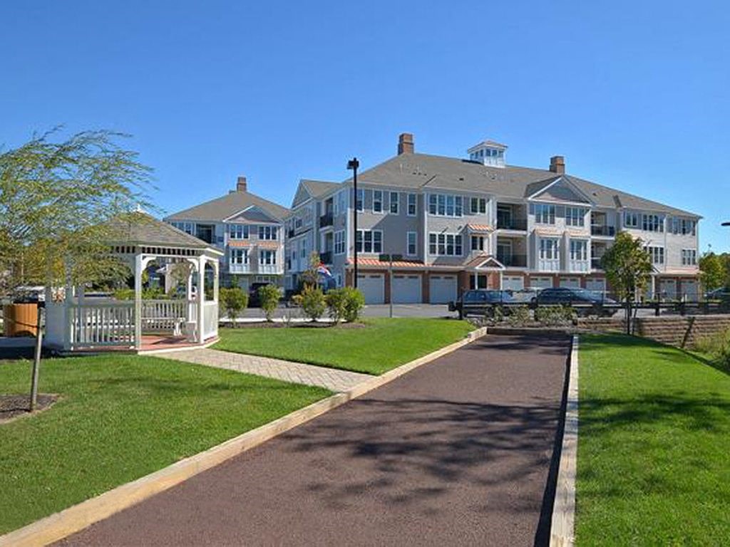 a large building with a walkway and a gazebo