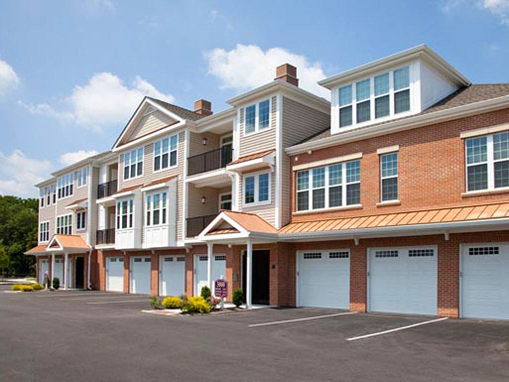 a row of town houses with white garage doors