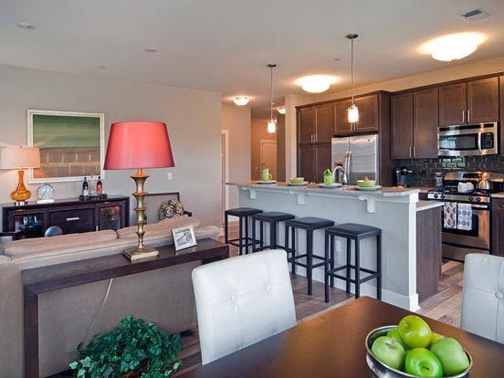 a kitchen with a bar and a table with chairs