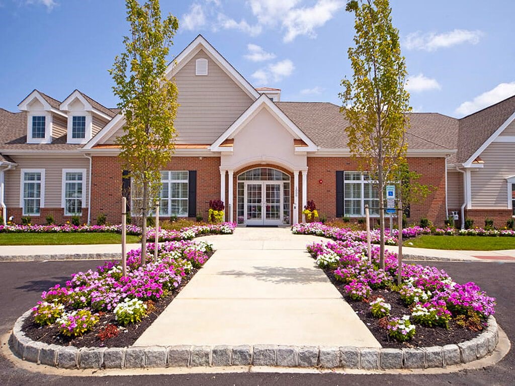 Pathway with flowers leading to clubhouse  at Barclay Glen Apartments, Williamstown, NJ