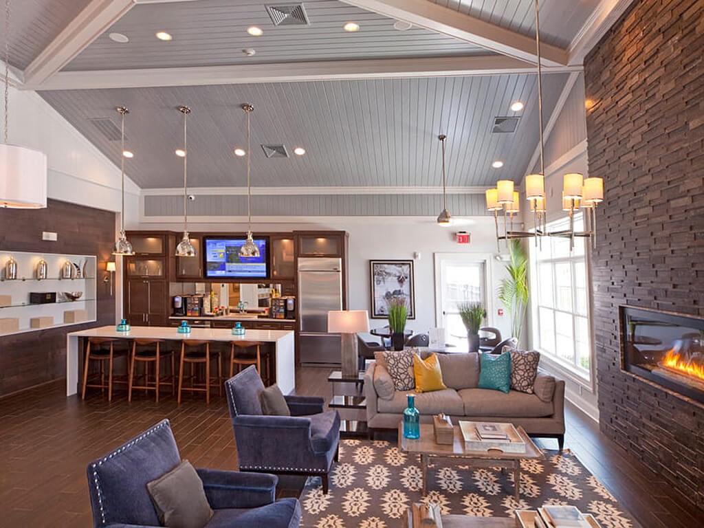 Clubhouse with a high ceiling, TV and seating in front of a fire  at Barclay Glen Apartments, Williamstown, NJ, 08094