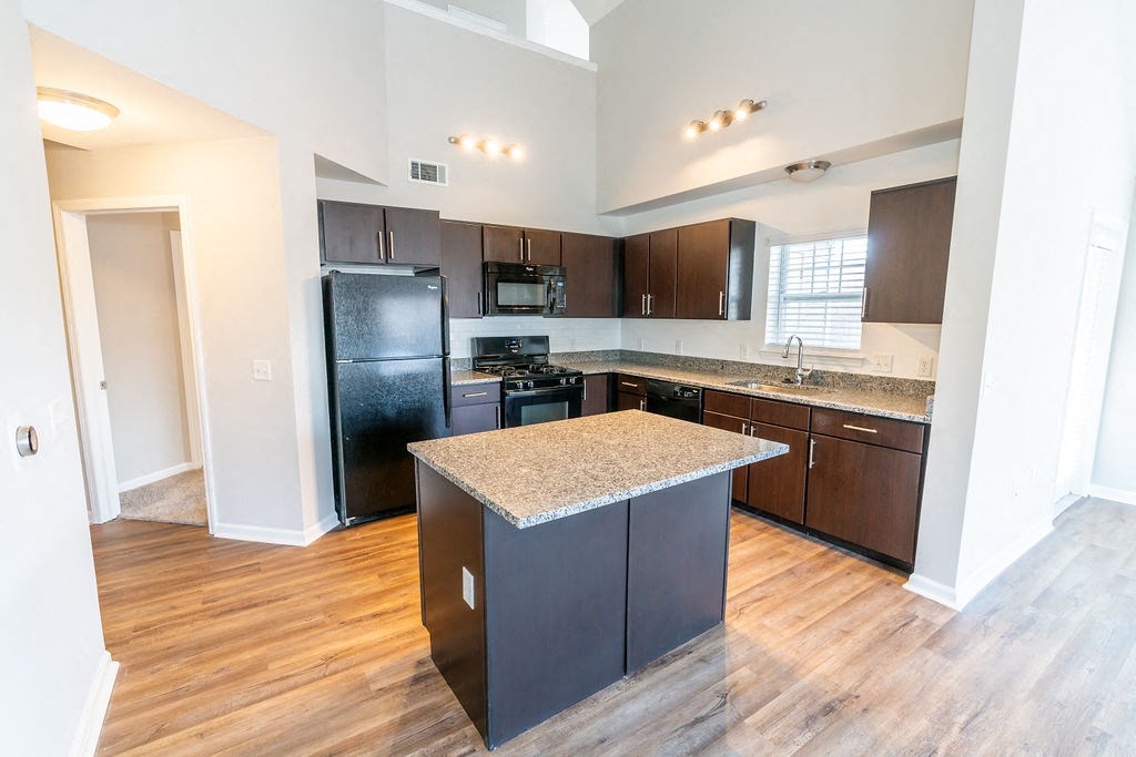 a kitchen with black appliances and granite counter tops at Merion Riverwalk Apartment Homes, Shelton, 06484