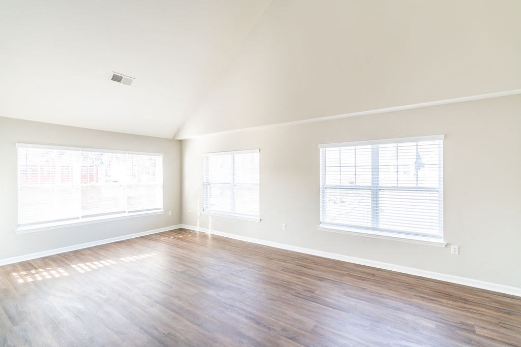 a living room with a hard wood floor and two windows at Merion Riverwalk Apartment Homes, Shelton, CT, 06484