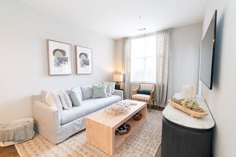 a living room with a couch and a coffee table at Merion Riverwalk Apartment Homes, Shelton, 06484
