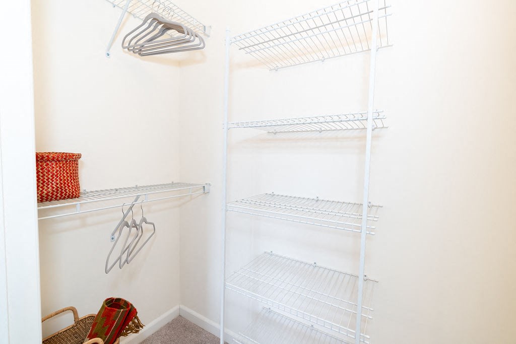 a small closet with white shelves and a white closet door at Merion Riverwalk Apartment Homes, Shelton, CT