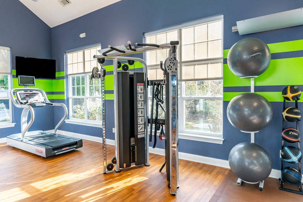 a home gym with exercise equipment and windows at Merion Stratford Apartment Homes, Stratford